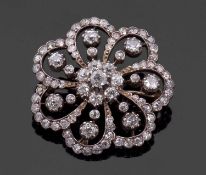 A late 19th/early 20th century diamond brooch, the central diamond flowerhead cluster, surrounded by