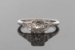 An early 20th century platinum and diamond ring, the central old brilliant cut diamond, estimated