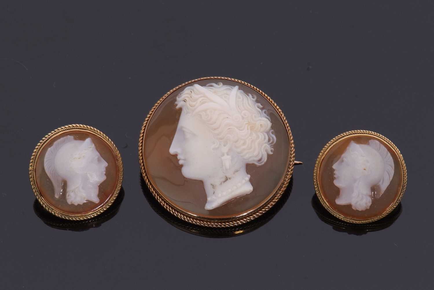 A hardstone carved cameo and earrings, the round hardstone cameo of a lady, with delicately curled