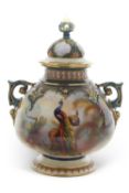 A impressive Hadley Worcester style vase and cover with green handles picked out in a gilt design,