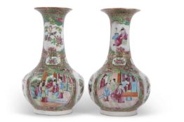 A pair of 19th Century Cantonese porcelain vases of baluster shape with typical designs of
