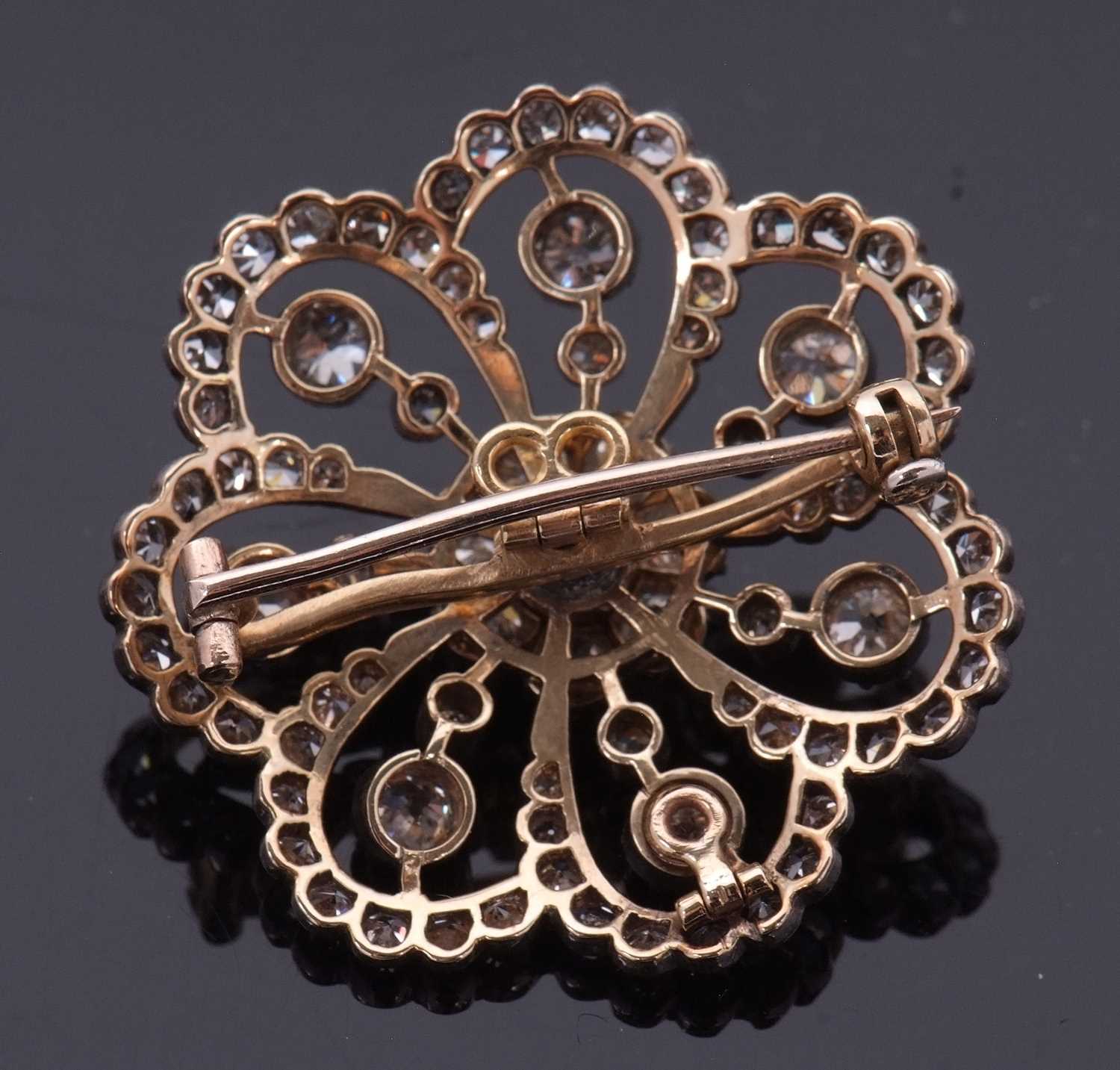 A late 19th/early 20th century diamond brooch, the central diamond flowerhead cluster, surrounded by - Image 3 of 8