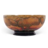 An early 20th century Moorcroft bowl decorated with the Eventide landscape pattern in shades of red,