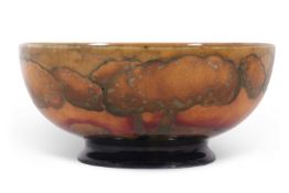 An early 20th century Moorcroft bowl decorated with the Eventide landscape pattern in shades of red,