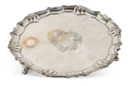 A George II silver salver of shaped circular form, shell and scroll border, engraved to the centre
