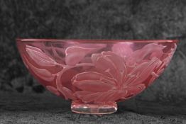 A Studio Glass bowl of red colour decorated with a design of lilies by Julia Linstead, 24cm