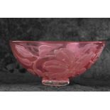 A Studio Glass bowl of red colour decorated with a design of lilies by Julia Linstead, 24cm