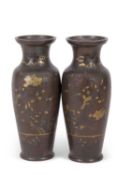 A pair of bronze vases with gilt design of birds amongst branches, 30cm high