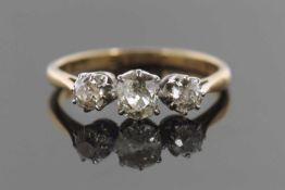An 18ct three stone diamond ring, the three old mine cut diamonds, total estimated approx. 0.