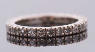 An 18ct white gold diamond eternity ring, set with small round diamonds, total estimated approx. 0.