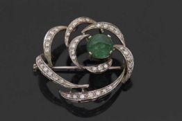 An 18ct white gold emerald and diamond brooch, set off-centre with a round emerald cabochon, approx.