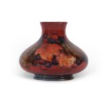 A Moorcroft vase of compressed ovoid form in the leaf and berry pattern with a flambe glaze