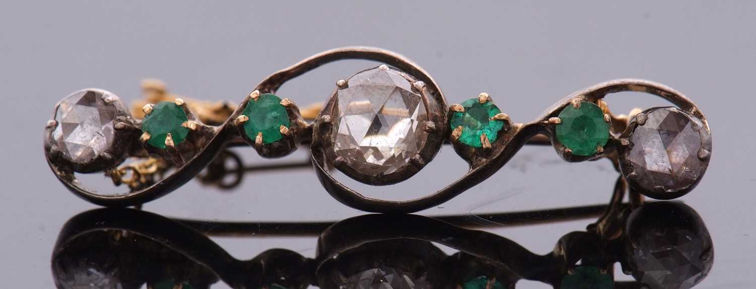 An emerald and diamond brooch, set with a central rose cut diamond, approx. 7.6mm diameter x 2.2mm - Image 4 of 8