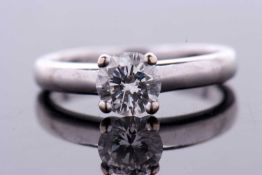 A certified diamond solitaire ring, the round brilliant cut diamond in a four claw mount,