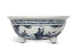 A Chinese transitional period bowl raised on 3 stub feet decorated in dark blue with figures