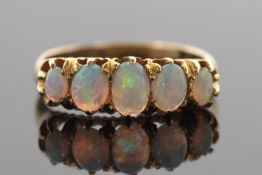 A five stone opal ring, the five slightly graduated oval opal cabochons, largest 6mm wide, claw