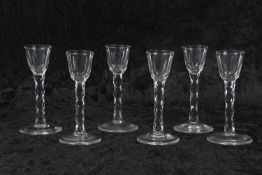 Group of six 18th Century cordial glasses, the bowls raised on faceted stems, 16cm high (3 with