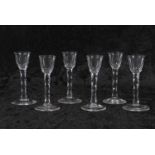 Group of six 18th Century cordial glasses, the bowls raised on faceted stems, 16cm high (3 with
