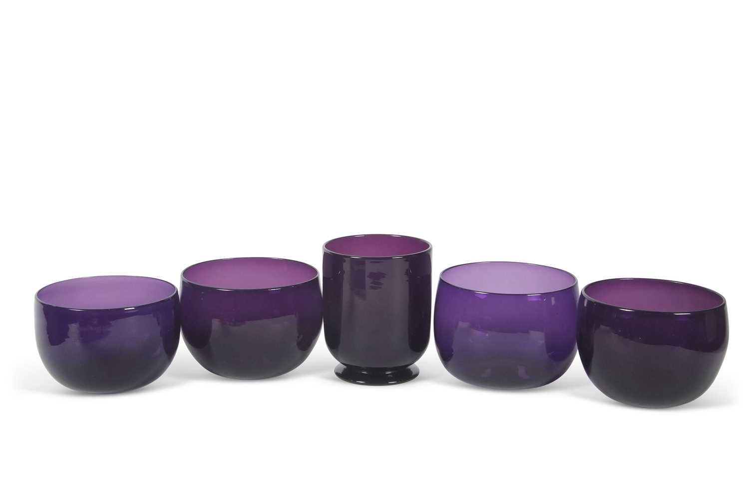 A group of early 19th Century amethyst coloured bowls including a amethyst glass mixing bowl,