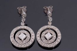 A pair of 18ct white gold diamond earrings, each comprised of central princess cut diamond in a four