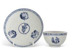 Lowestoft porcelain Hughes type tea bowl and saucer circa 1765, the moulded body with vignettes of