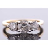 An 18ct three stone diamond ring, the three slightly graudated round brilliant cut diamonds, total