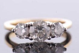An 18ct three stone diamond ring, the three slightly graudated round brilliant cut diamonds, total