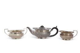 Late Victorian three piece silver tea service of compressed round form with applied gadrooned rims