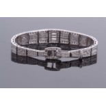 An 18ct white gold and diamond set Art Deco style bracelet, the tapered, articulated bracelet with