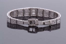 An 18ct white gold and diamond set Art Deco style bracelet, the tapered, articulated bracelet with