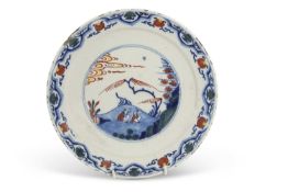 An unusual early 18th century English Delft dish with polychrome Chinoiserie type design in