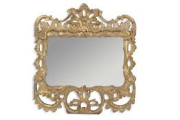 A Georgian gilt wood framed wall mirror, the frame of pierced, carved and foliate decorated form