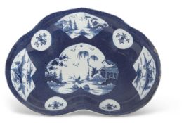 A Bow Porcelain kidney shaped dish circa 1765, the blue ground with Chinoiserie panels, pseudo