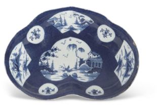 A Bow Porcelain kidney shaped dish circa 1765, the blue ground with Chinoiserie panels, pseudo