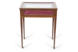 An Edwardian Bijouterie table with hinged rectangular top over a plush lined interior raised on