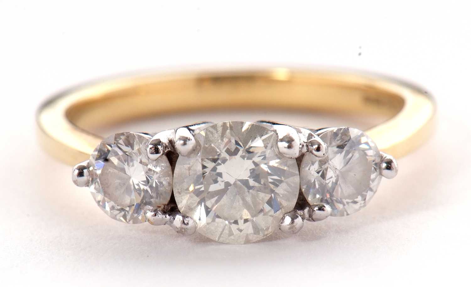 An 18ct three stone diamond ring, the three slightly graudated round brilliant cut diamonds, total - Image 4 of 11