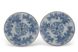 A pair of 18th Century English Delft plates decorated in Chinese porcelain style, one with label