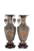 A pair of late 19th Century Chinese export silver vases of tapering baluster form, decorated with