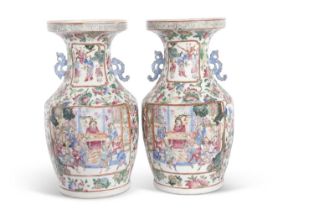 A pair of late 19th Century Cantonese vases decorated in famille rose with panels of Chinese