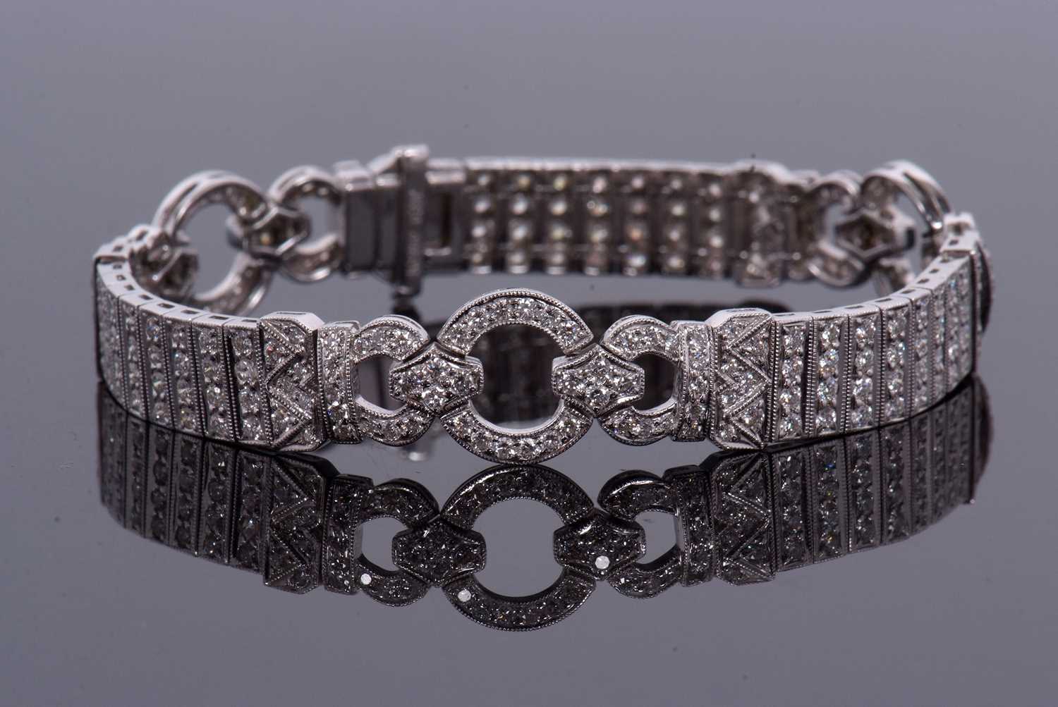 An 18ct white gold and diamond Art Deco style bracelet, comprised of three circlets of small round
