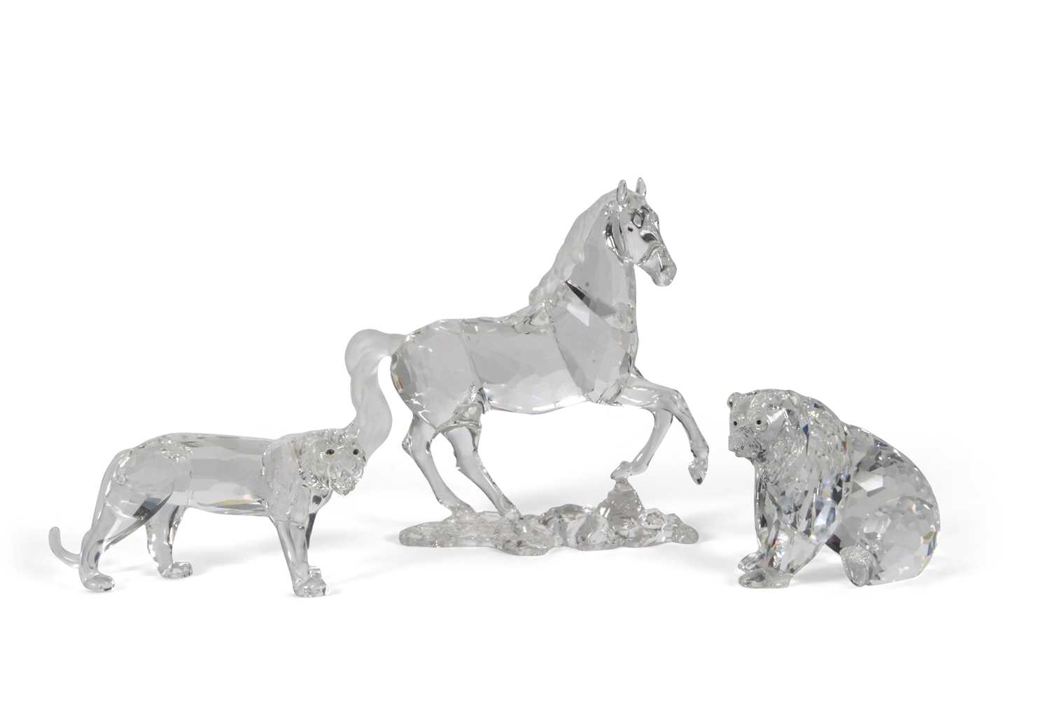 A Swarovski model of a prancing horse on shaped base together with a model of a bear and a tiger,