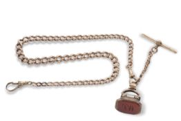 A Victorian yellow metal pocket watch chain with fob, stamps can be found on the T bar and clip
