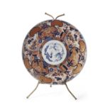 An impressive Japanese porcelain charger decorated in Imari fashion, Meiji period, 63cm diameter