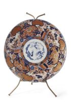 An impressive Japanese porcelain charger decorated in Imari fashion, Meiji period, 63cm diameter