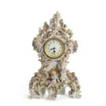 A large 19th Century continental porcelain clock case with moulded floral decoration, painted