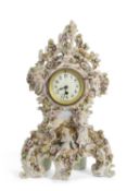 A large 19th Century continental porcelain clock case with moulded floral decoration, painted