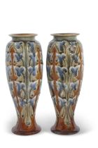 A pair of Royal Doulton Art Nouveau vases with incised designs in green and brown by Frank