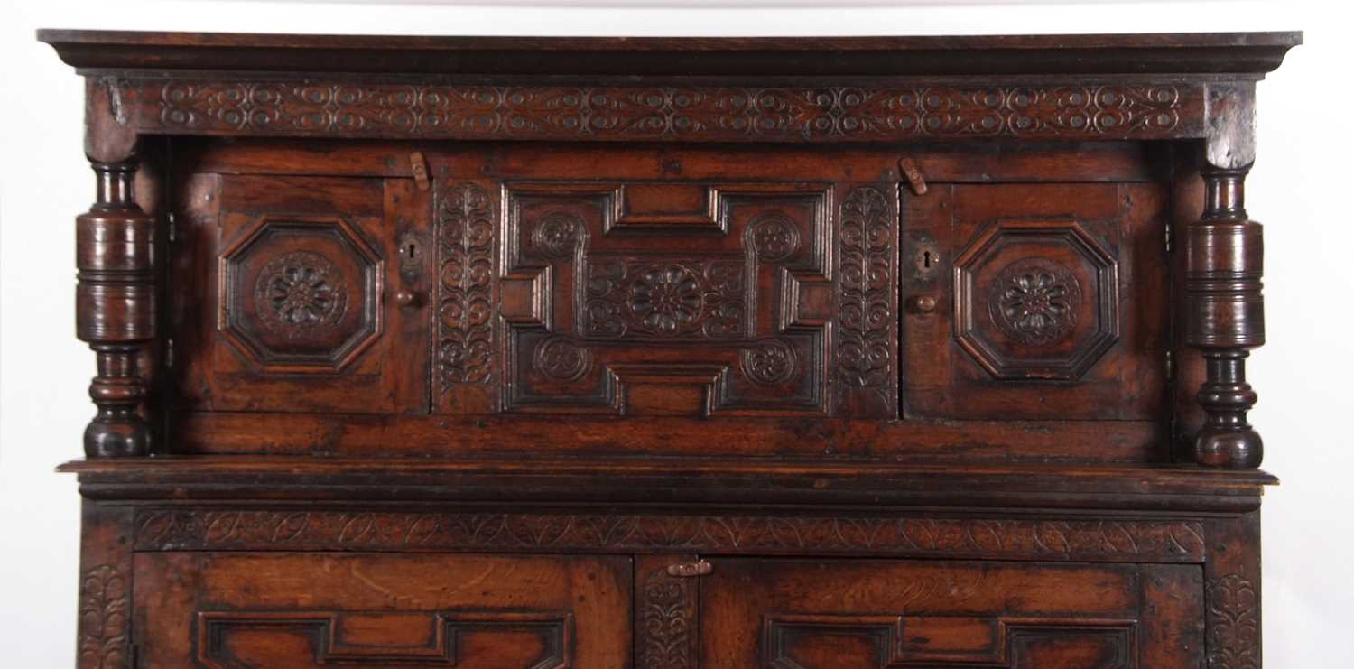 A large 17th Century oak court cupboard with moulded cornice over a top section with two panelled - Image 3 of 12