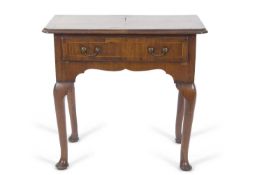 An early 18th Century walnut low boy, the top with quartered veneers and canted front corners over a