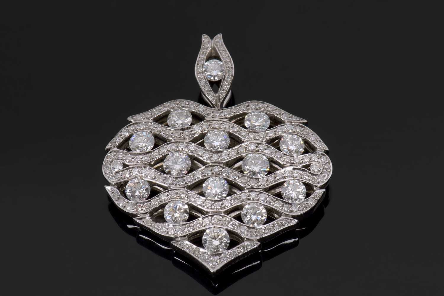 An 18ct white gold diamond heart pendant by Cyril Waskoll, the heart covered with a diamond set